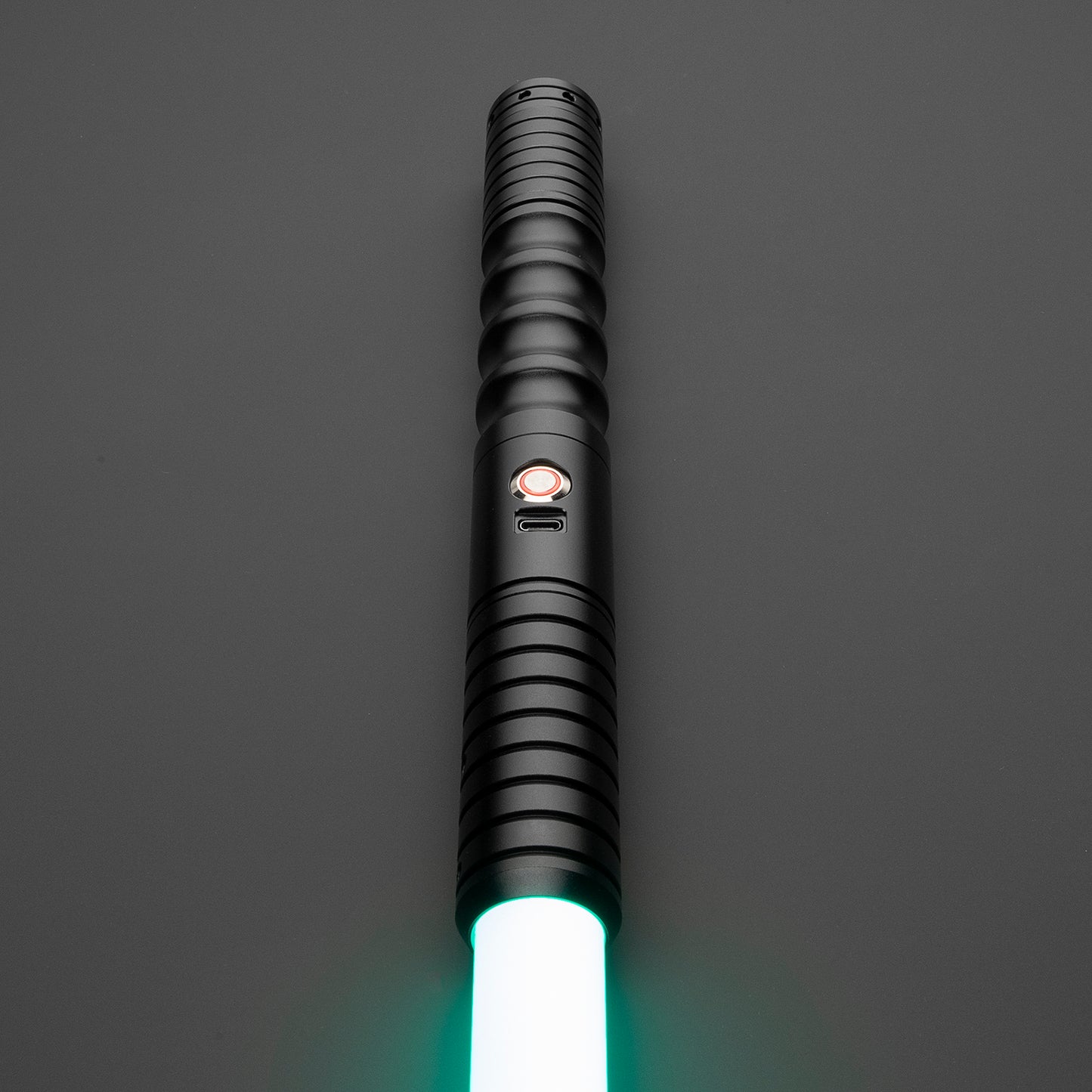 Illuminated Mason Light Saber resting on a smooth surface - Battle Sabers