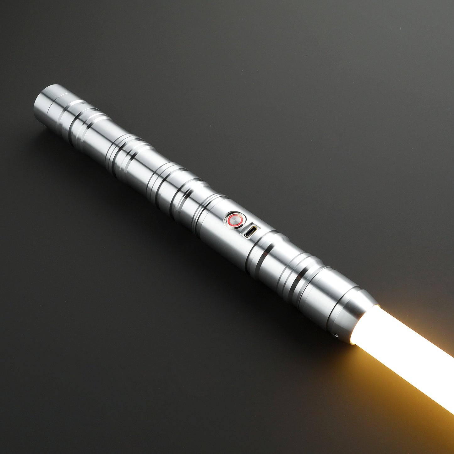 Monolith Silver Light Saber resting on a smooth surface - Battle Sabers